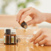 A mother mixes essential oils together for natural sinus relief.