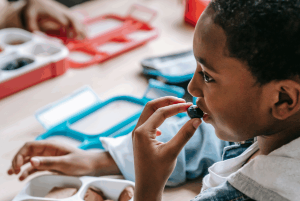 A young boy eating a healthy meal, one of the natural ways to reduce sinus inflammation and support overall health.