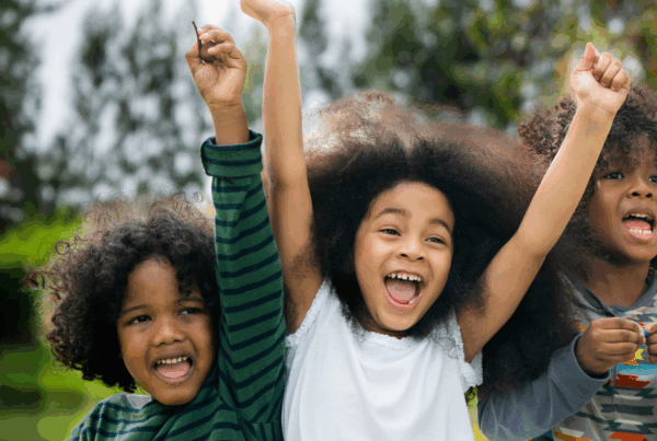 A group of happy children outside.